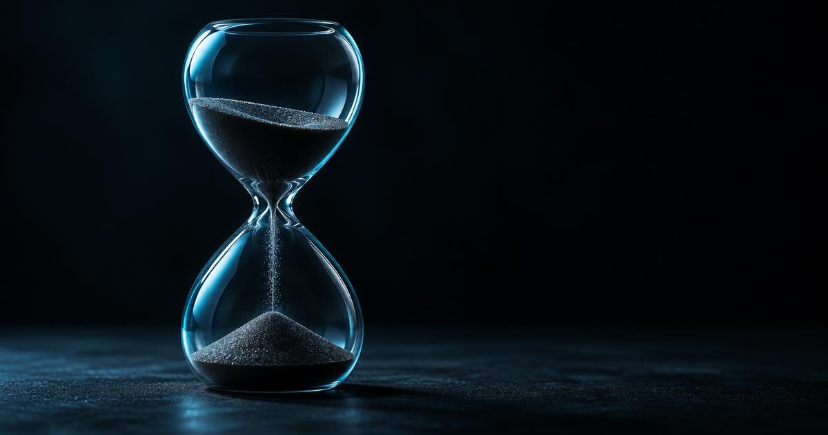 A glass hourglass with sand falling, lit in cyan-blue against a near-black background